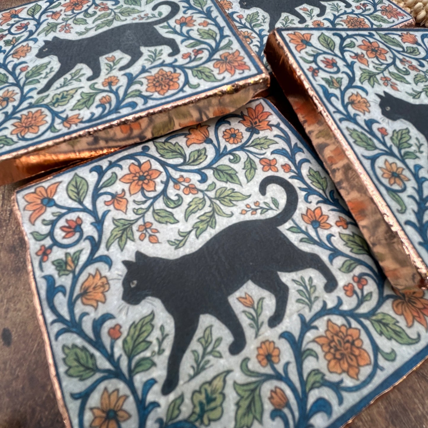 Set of four elegant black cat coasters with copper edging, William Morris
