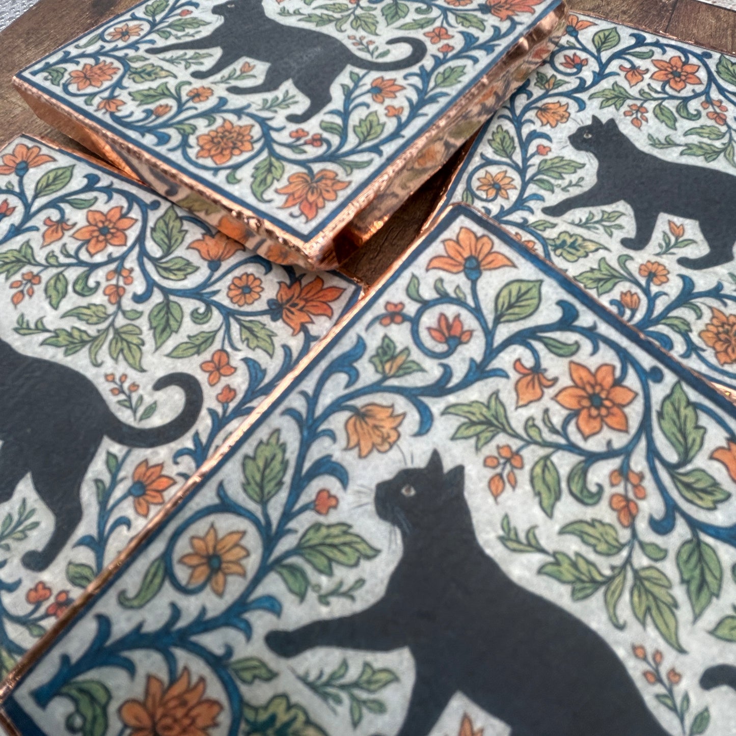 Set of four elegant black cat coasters with copper edging, William Morris